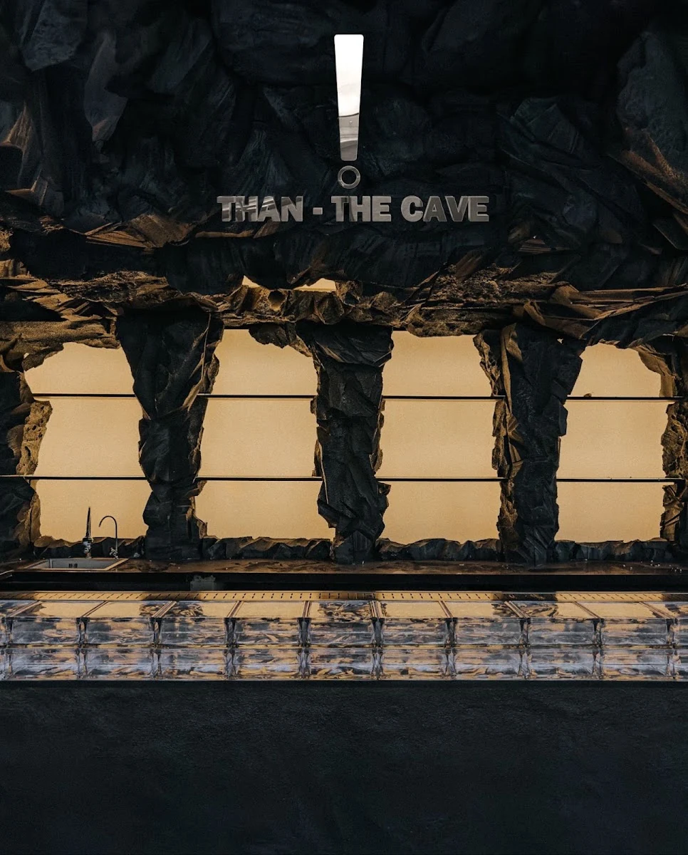 Than - The Cave bar wall and blue glass-block counter