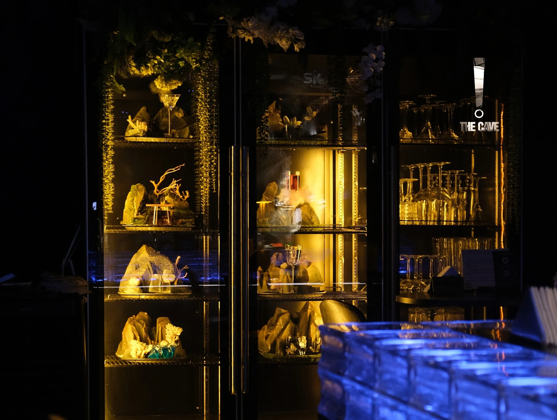 Backlit mineral objects beside the blue bar