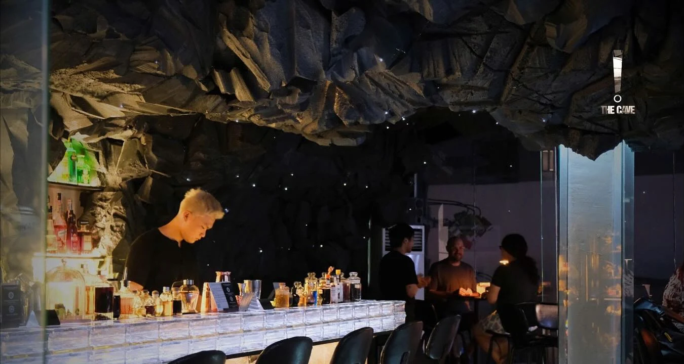 Cave ceiling, bartender and bar seating inside Than - The Cave
